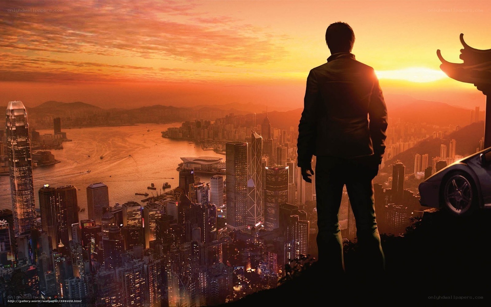 Man overlooking city at sunset