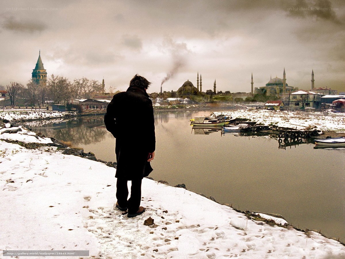 Man overlooking snowy cityscape