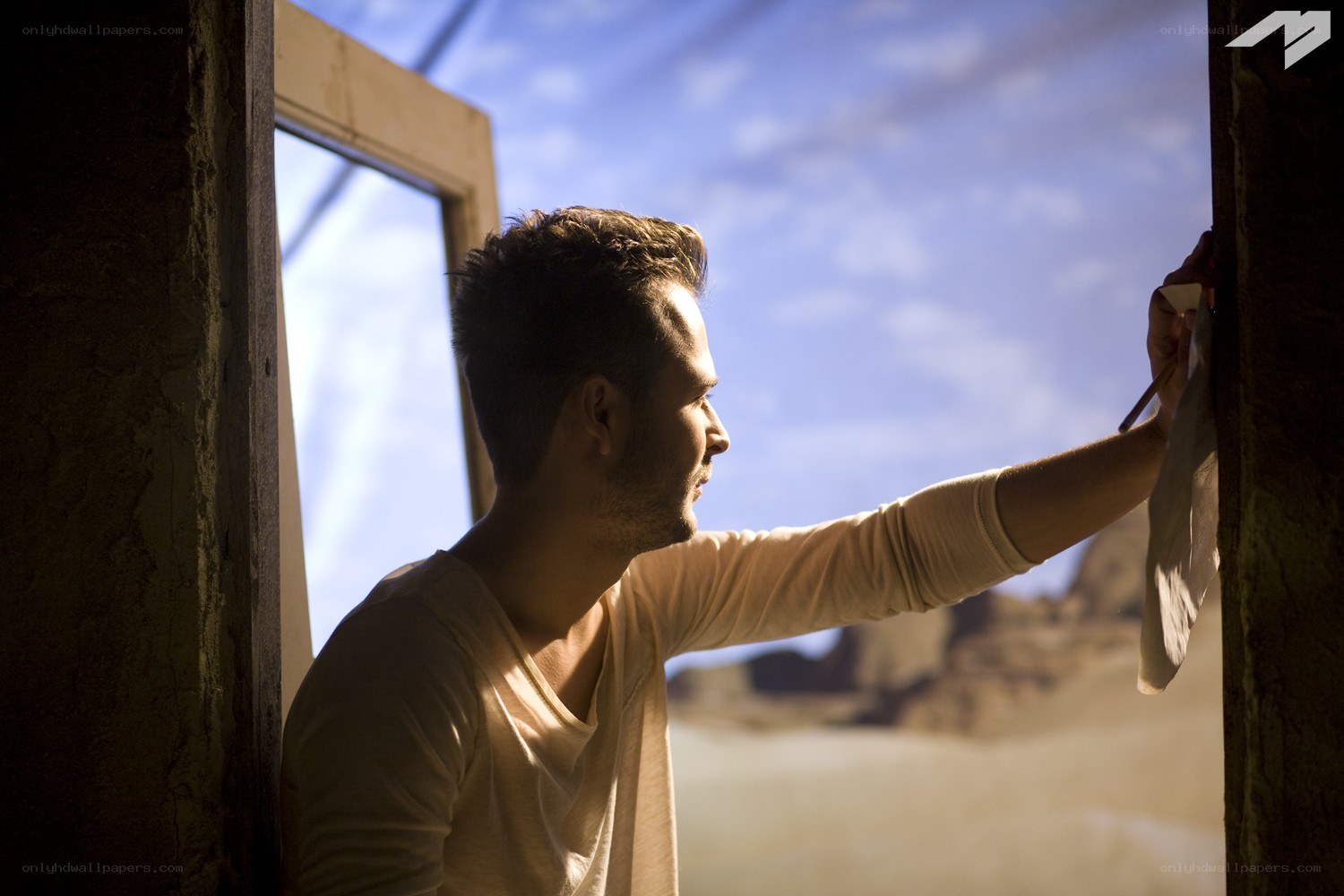 man painting in desert
