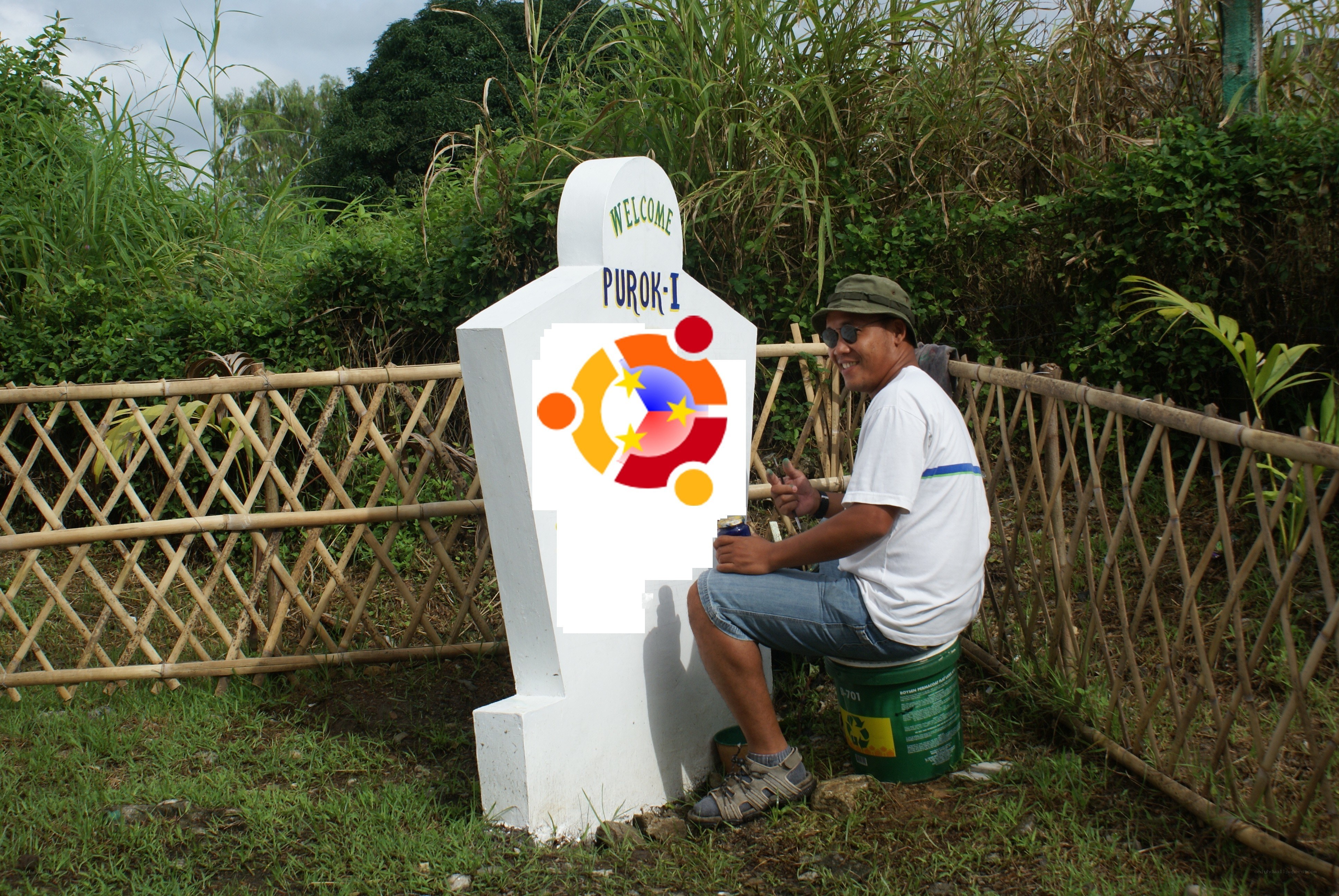 Man painting welcome sign