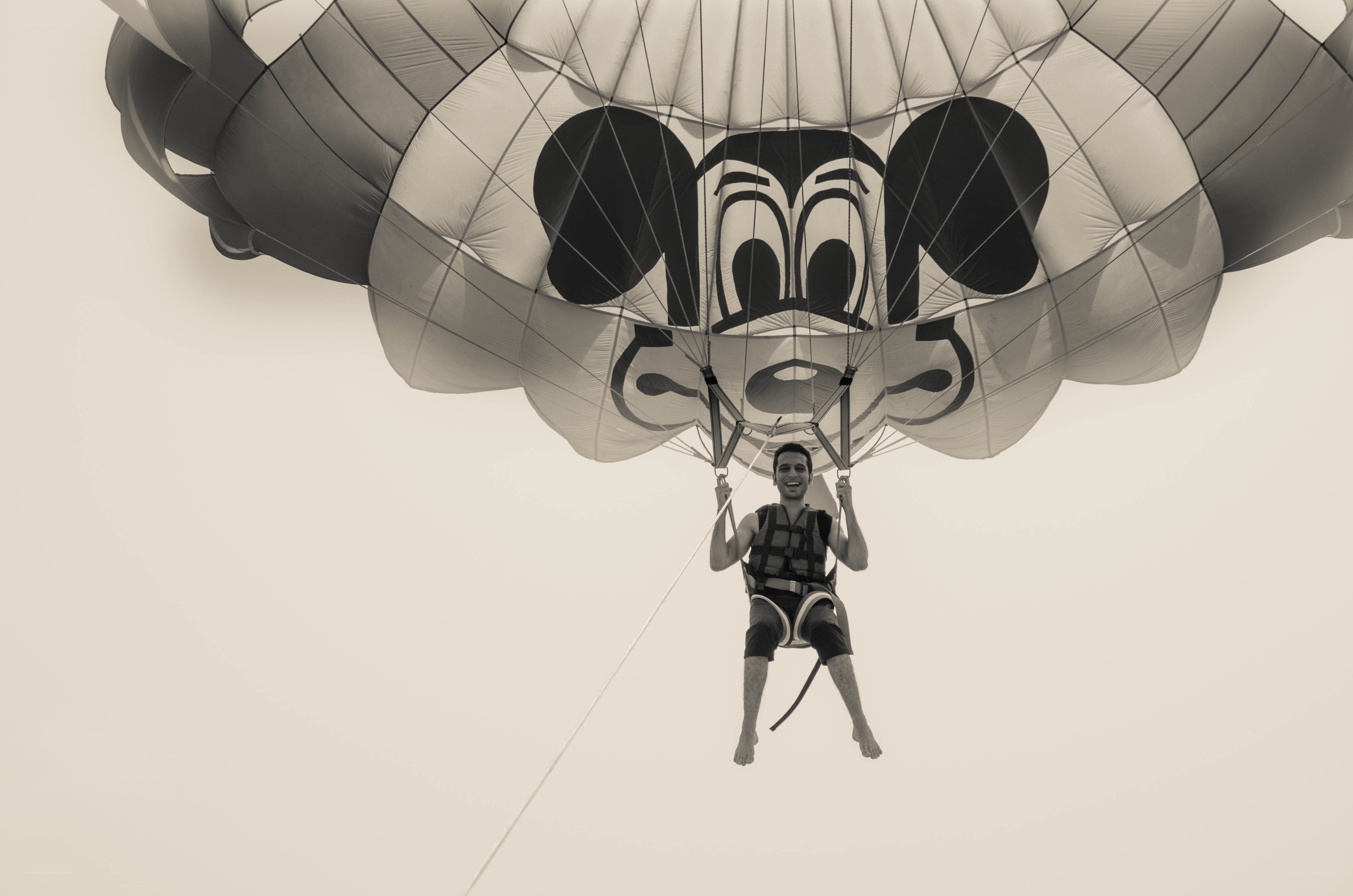 Man parasailing with Mickey Mouse canopy