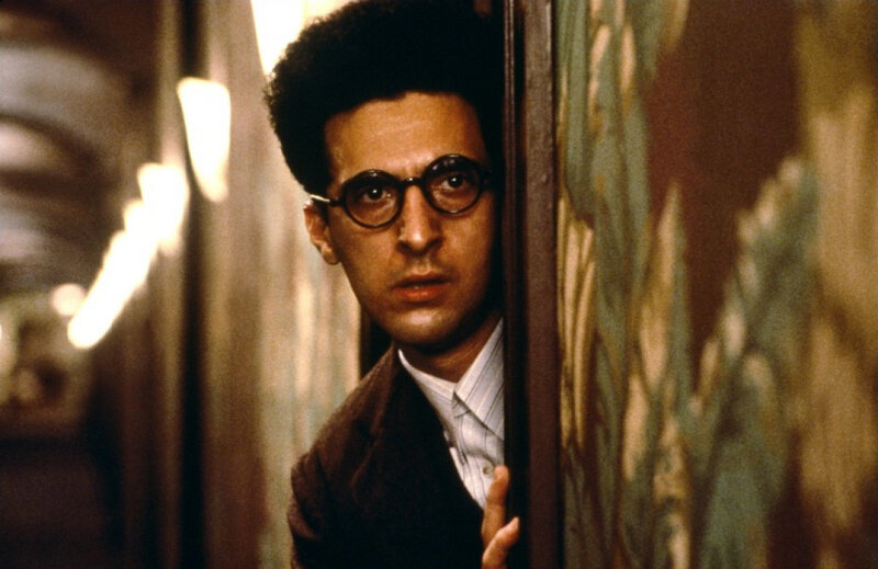 man peeking from behind a wall