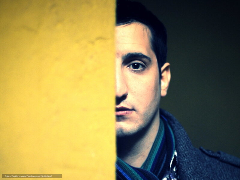 man peeking from behind wall