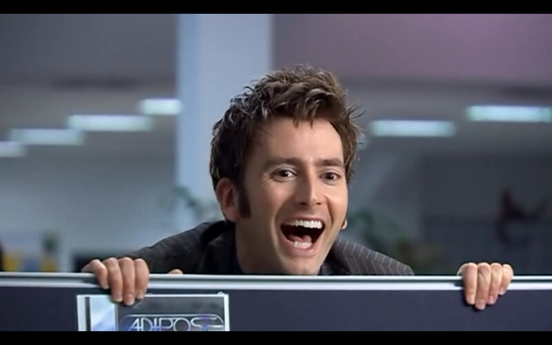 man peeking over desk