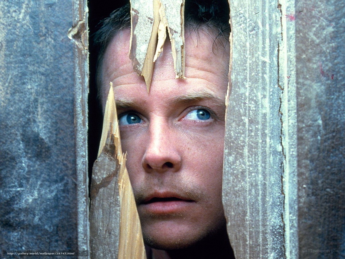 man peeking through broken wood
