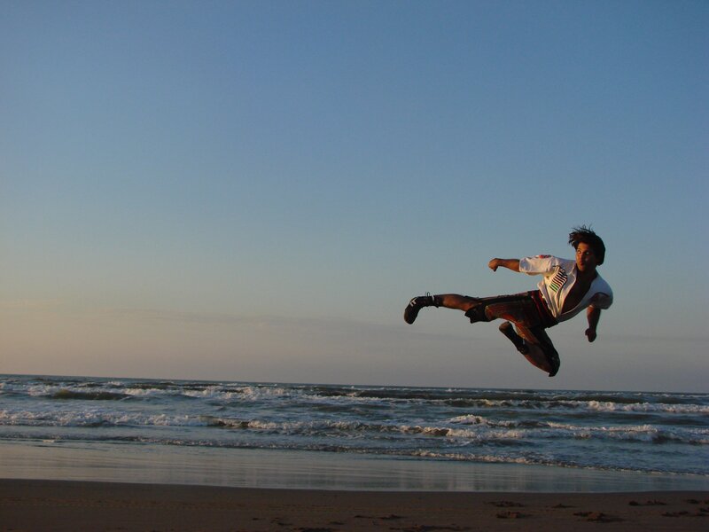 Man performing kick on beach