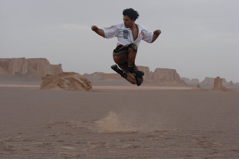 Man performing martial arts in desert