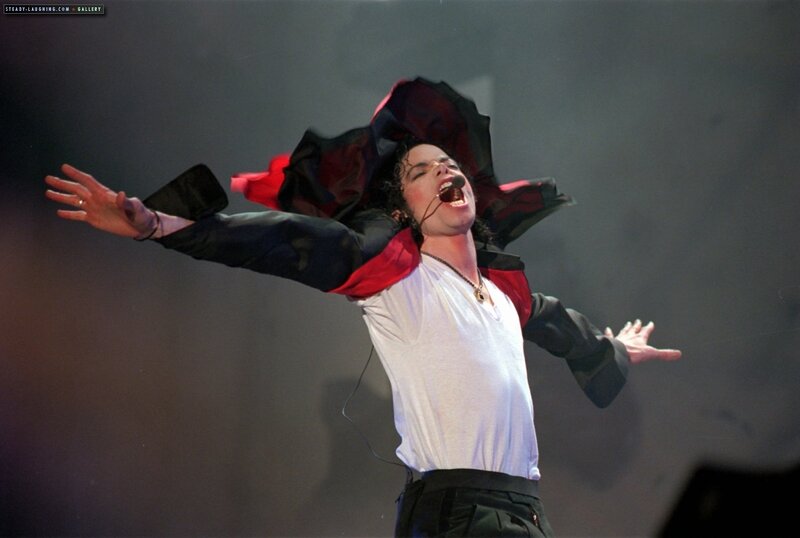 Man Performing on Stage — Black, Dramatic