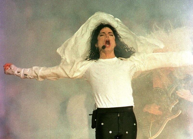 Man Performing on Stage — White, Dramatic