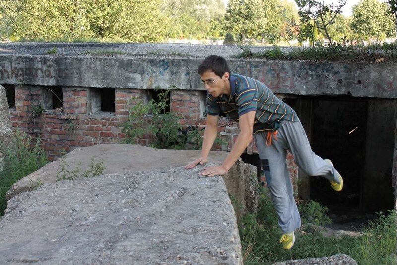 Man Performing Parkour — Gray