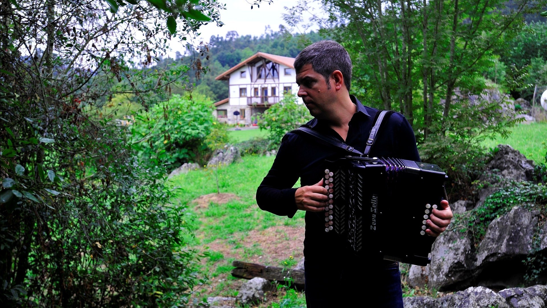 Man playing accordion in garden