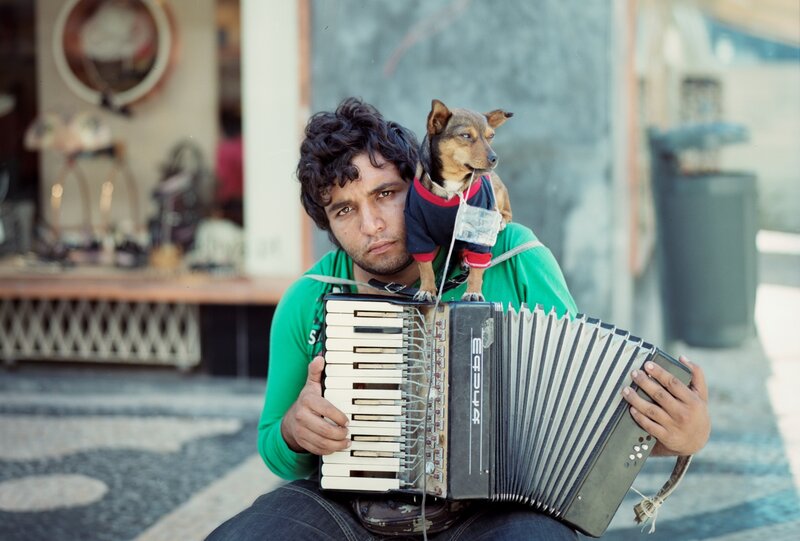 Man playing accordion with dog