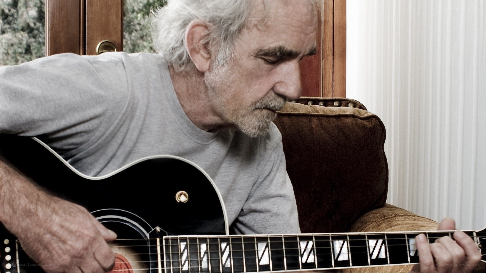 man playing acoustic guitar