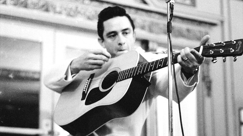 man playing acoustic guitar