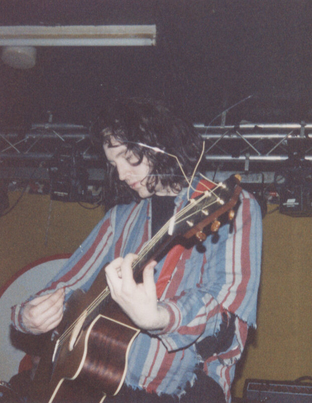 man playing acoustic guitar
