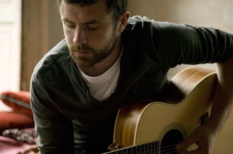 man playing acoustic guitar