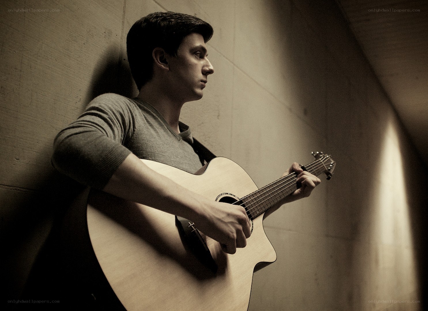 man playing acoustic guitar