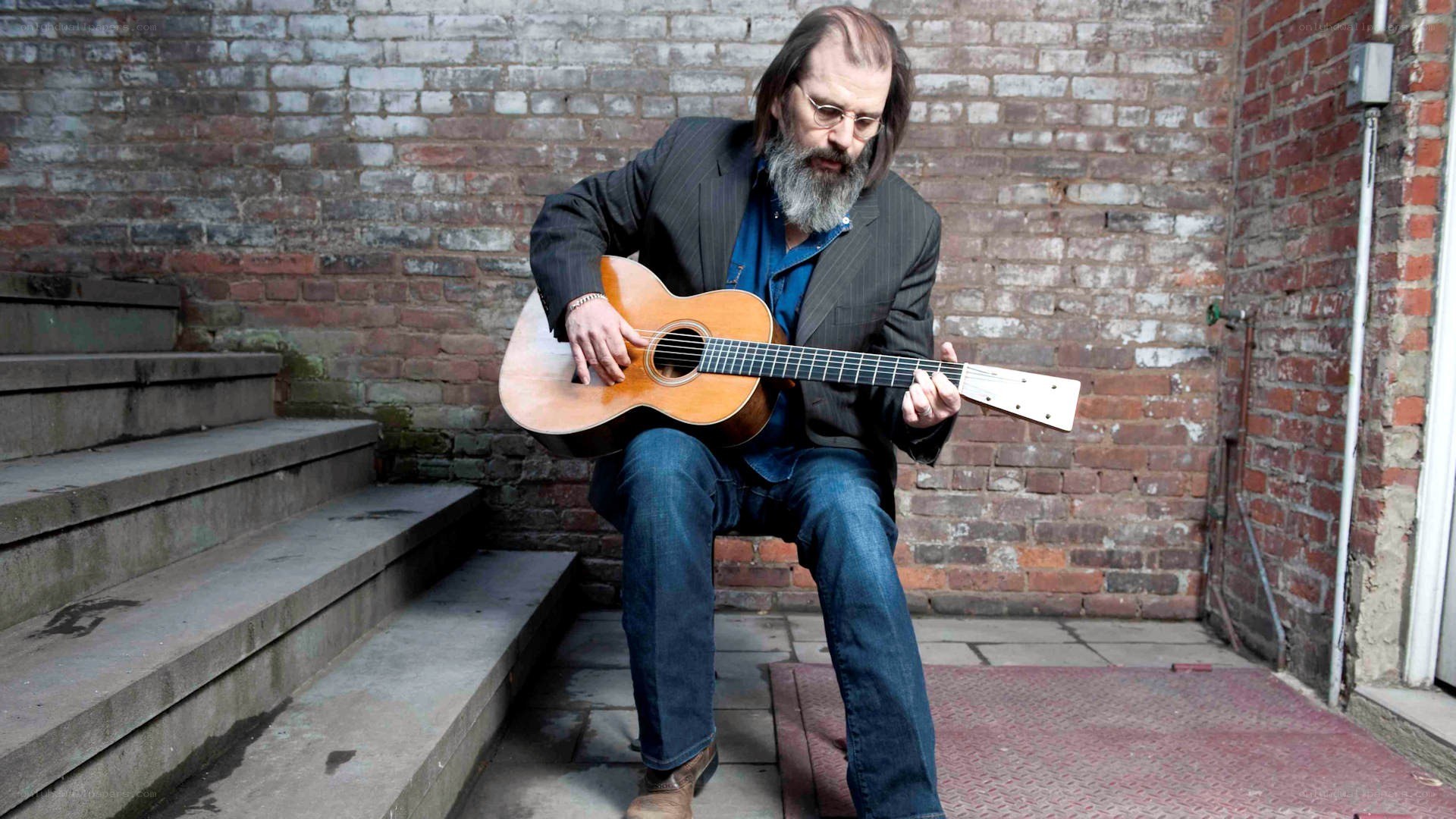 man playing acoustic guitar