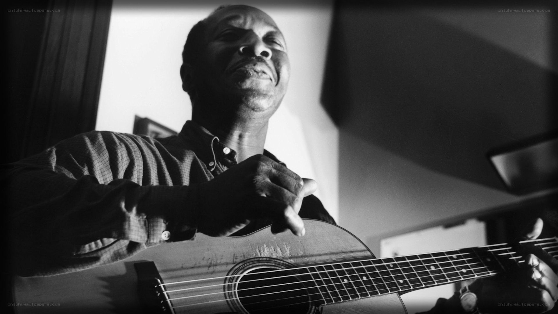 man playing acoustic guitar