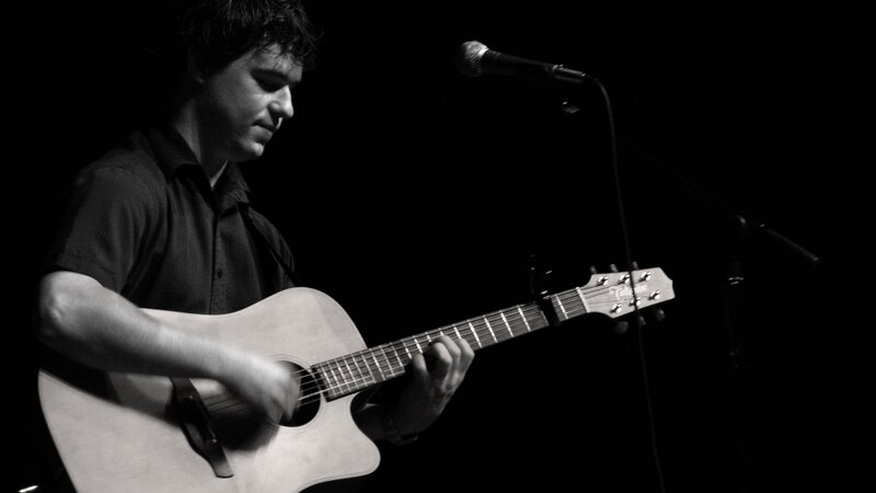 Man Playing Acoustic Guitar — Black, Dramatic