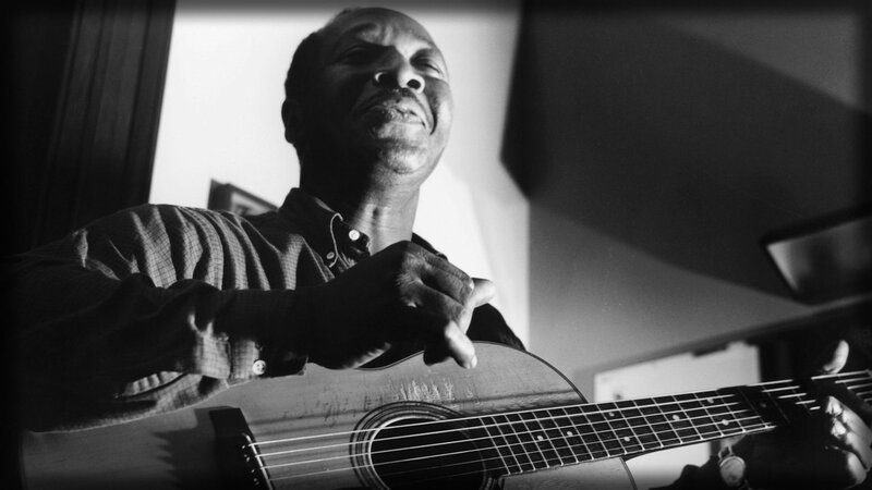 Man Playing Acoustic Guitar — Black