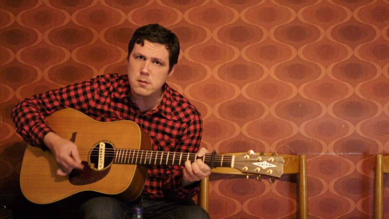 Man Playing Acoustic Guitar — Brown, Intense