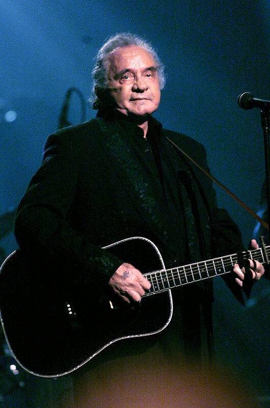 Man playing acoustic guitar on stage