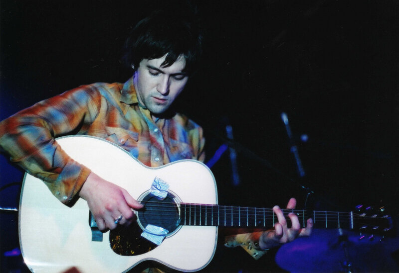 Man playing acoustic guitar on stage