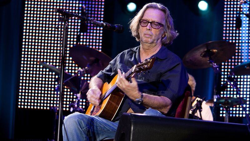 Man playing acoustic guitar on stage