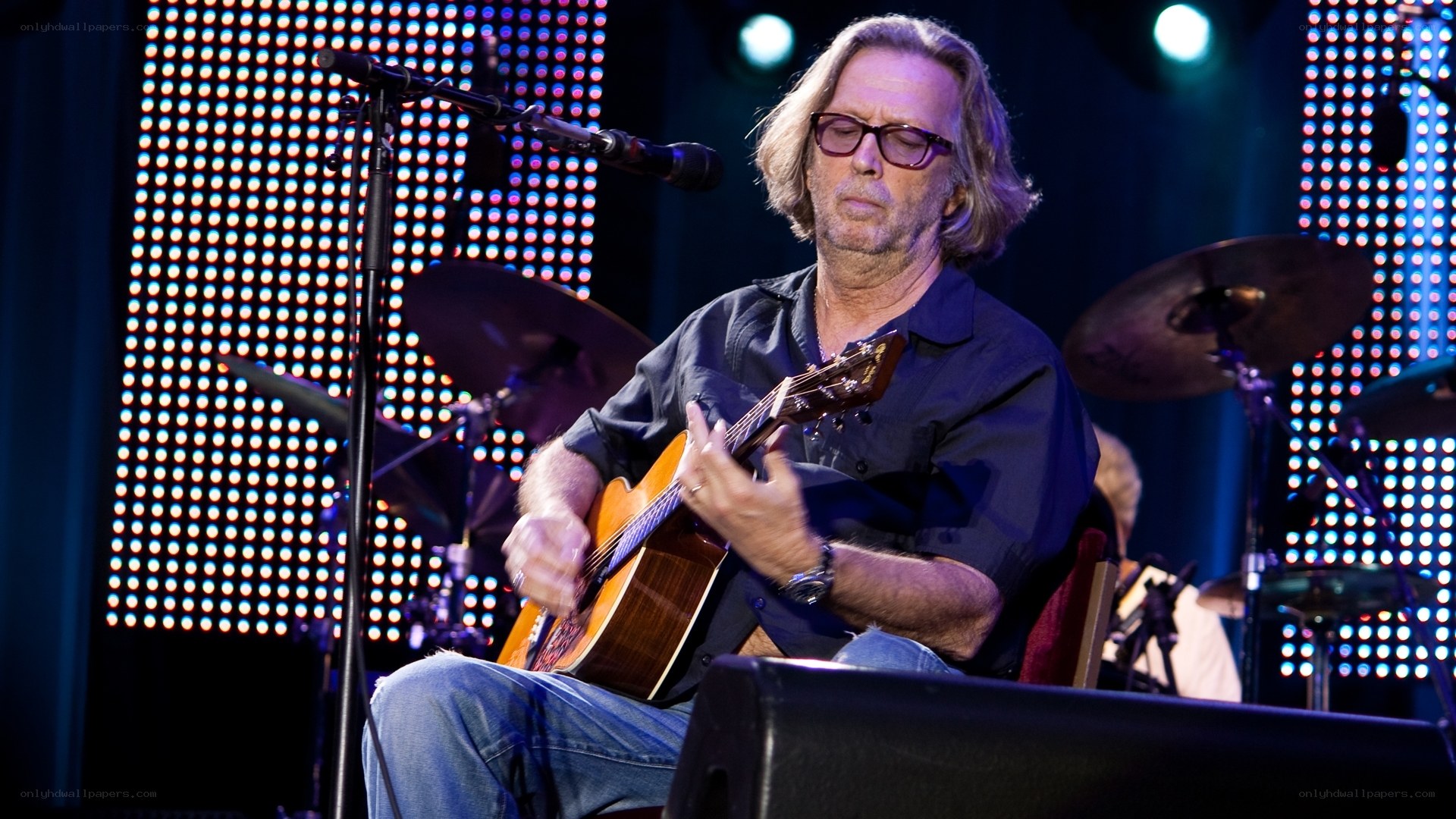 Man playing acoustic guitar on stage