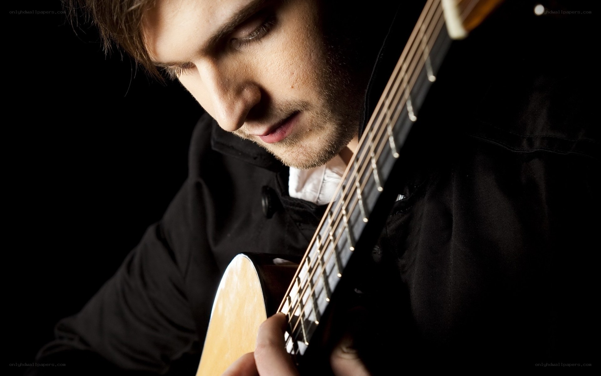 man playing acoustic guitar
