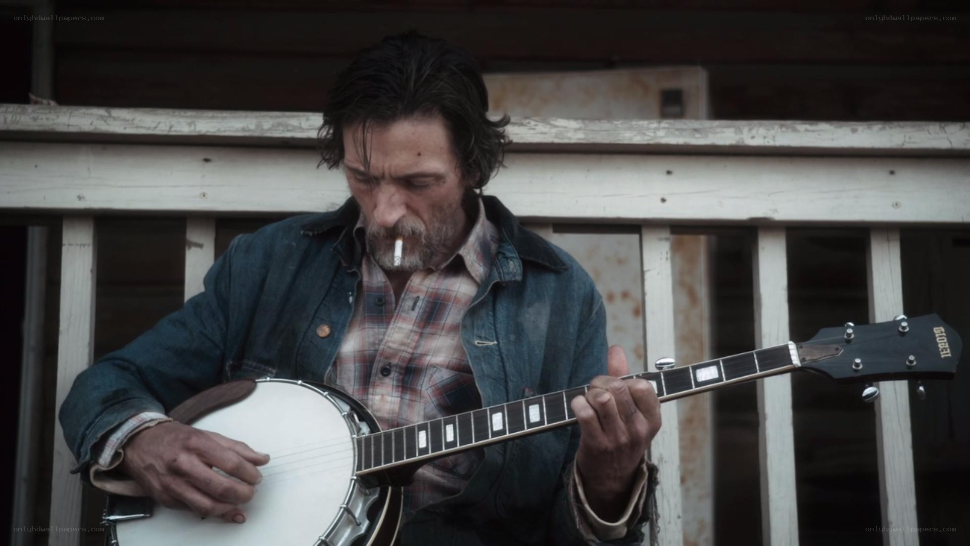 man playing banjo with cigarette
