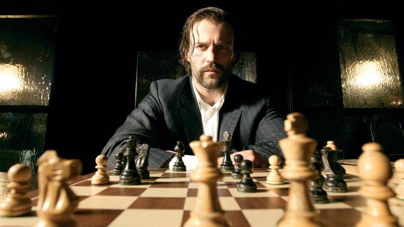 Man playing chess in dark room