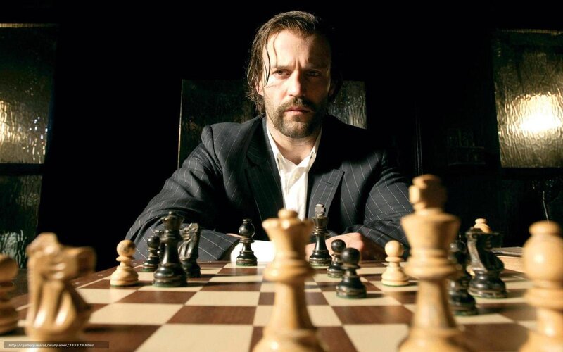 Man playing chess in dark room