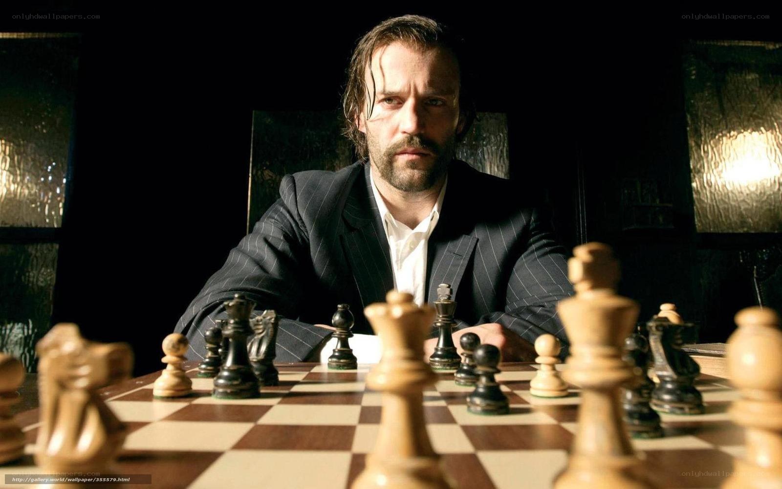 Man playing chess in dark room