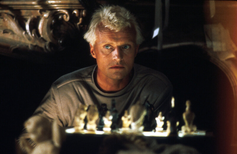 Man playing chess in dim light