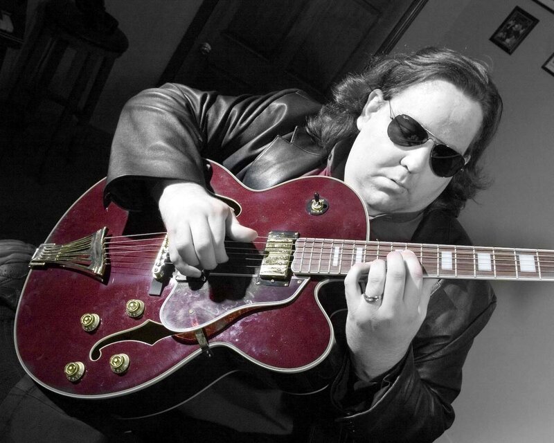 man playing electric guitar