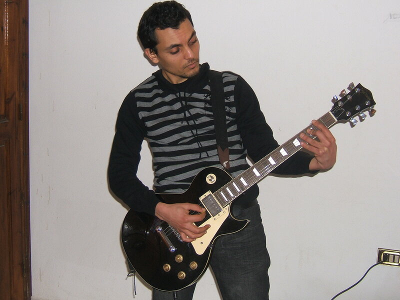 man playing electric guitar