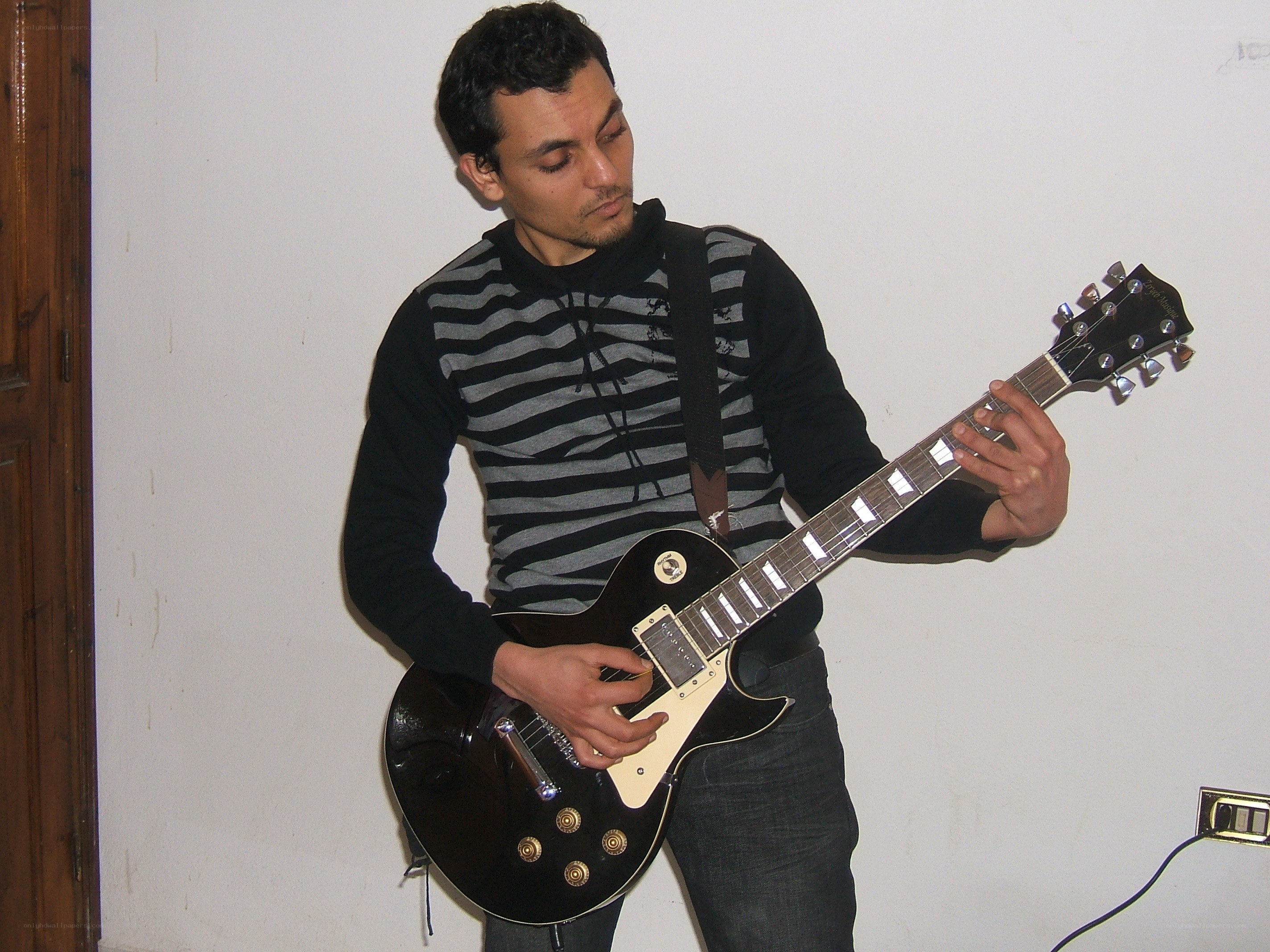 man playing electric guitar