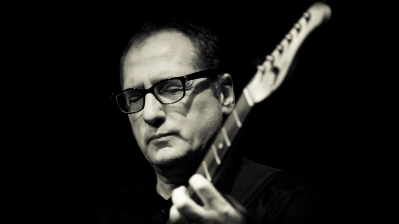 Man Playing Electric Guitar — Black, Dramatic, Photograph, Glasses
