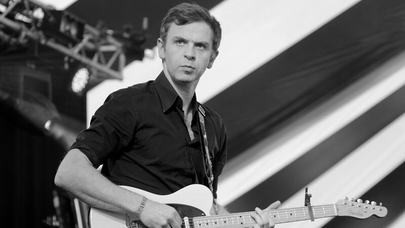 Man Playing Electric Guitar — Black, Focused, Photograph, Stage Lights