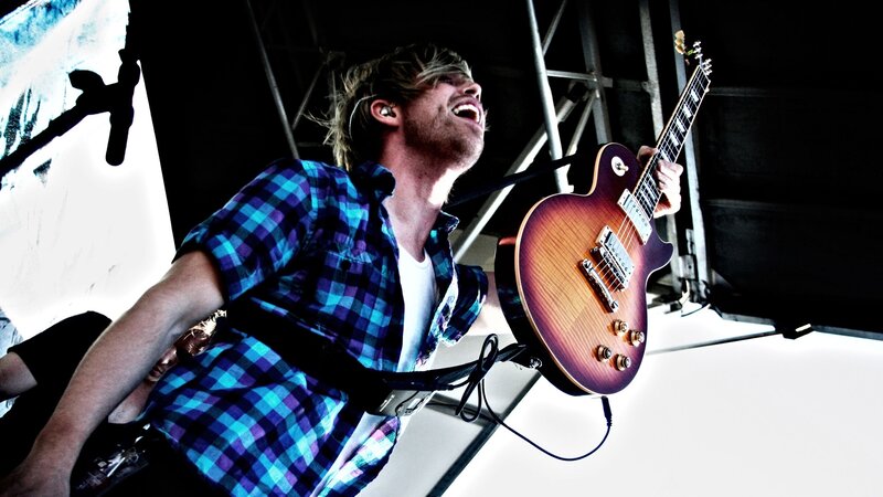 Man Playing Electric Guitar — Blue, Energetic, Photograph