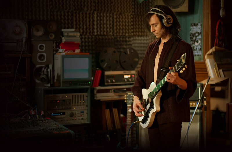 Man Playing Electric Guitar — Brown, Focused