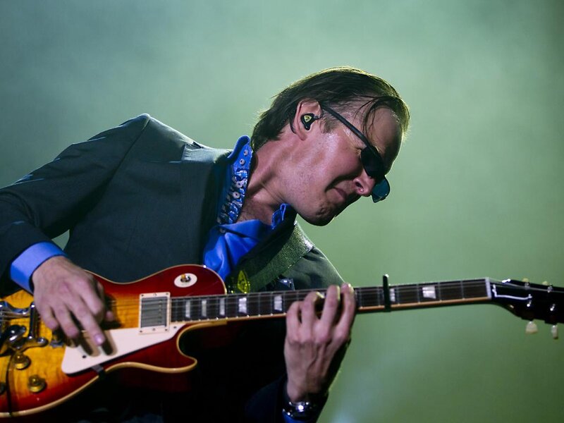 Man Playing Electric Guitar — Green, Focused