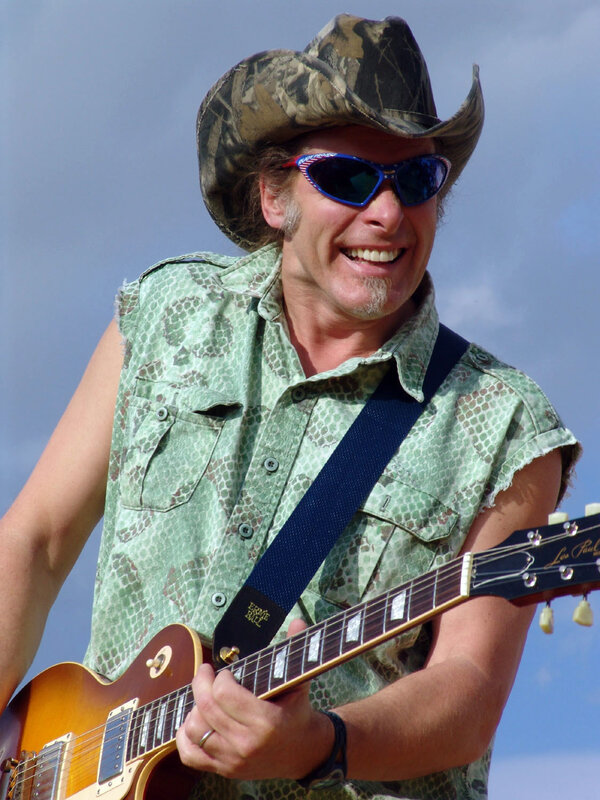Man playing electric guitar outdoors