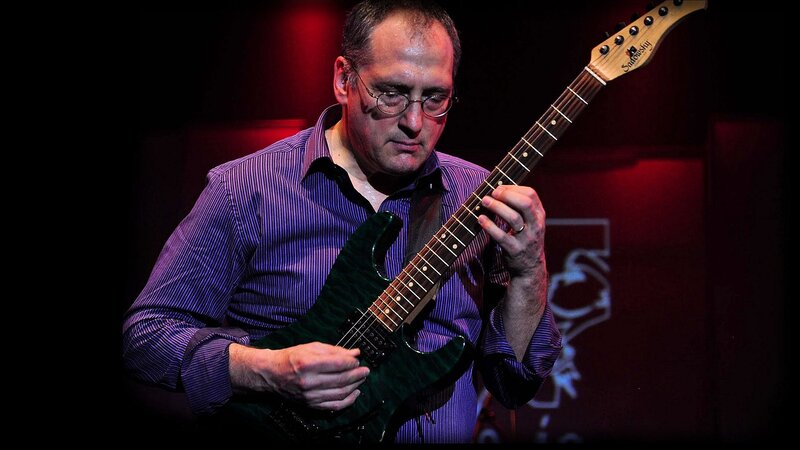 Man Playing Electric Guitar — Purple, Focused
