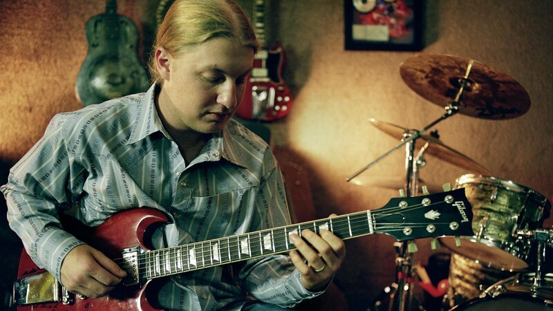 Man Playing Electric Guitar — Red, Focused, Photograph