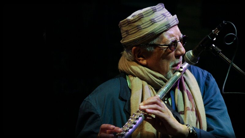 Man Playing Flute — Black, Focused