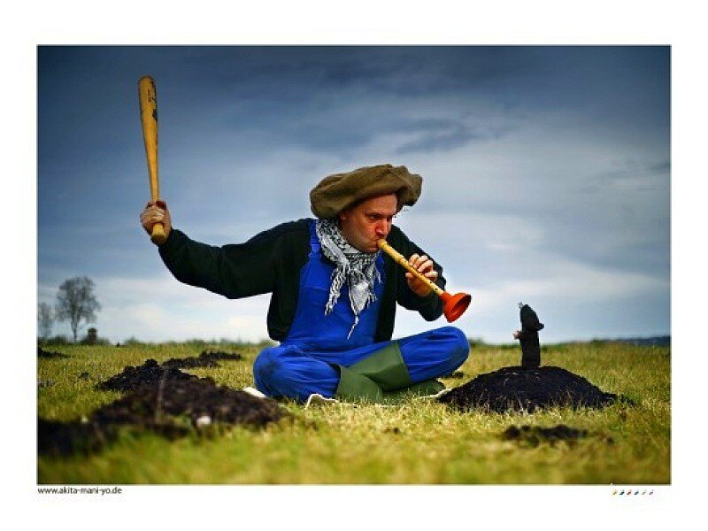 Man playing flute in field
