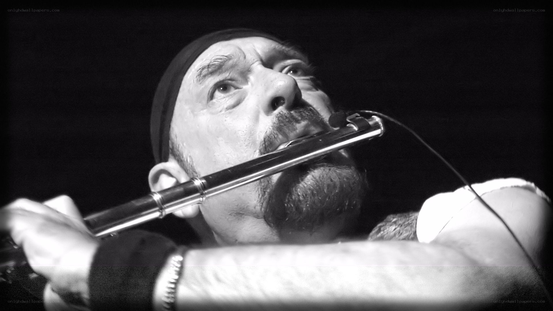 man playing flute on stage